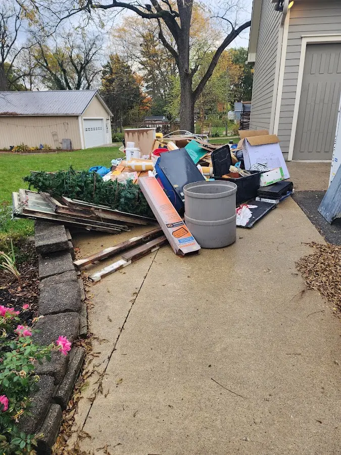 Dumpster being loaded with debris for Estate Cleanout Dumpster Rental in Monte Vista